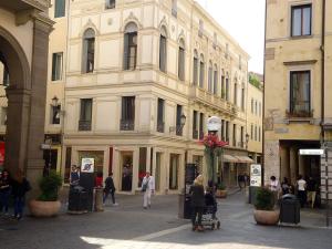 a group of people walking on a street in front of a building at Canton del Gallo in Padova