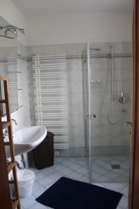 a bathroom with a shower and a sink and a tub at Ferienhaus Pepi in Strobl