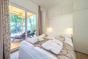a bedroom with a bed with white pillows on it at Glavotok Premium Green Camp in Krk +84 photos