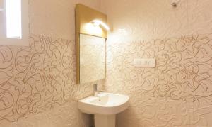 a bathroom with a sink and a mirror at Hotel Dvaraka Inn in Bengaluru +32 photos
