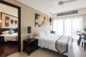 A bed or beds in a room at Howard Johnson Resort Sanya Bay