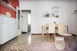 a kitchen and dining room with a table and chairs at Flat Barbariga 12 in Trieste