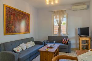 a living room with two couches and a coffee table at Le Paradis d' Elli in Lakíthra