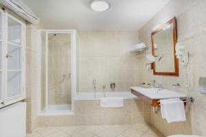 
a bathroom with a sink, toilet and shower at Boutique Hotel Constans in Prague
