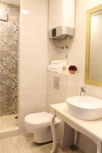 a bathroom with a sink and a toilet and a shower at Luxury Split apartment with view in Split