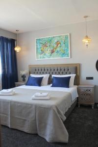 a bedroom with a large bed with blue pillows at Luxury Split apartment with view in Split