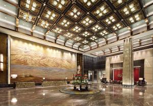 a lobby with a large painting on the wall at Wanda Vista Xining in Xining