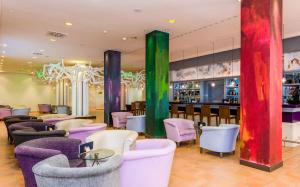 a restaurant with colorful chairs and a bar at TUI Blue Isla Cristina Palace - Adults Recommended in Isla Cristina