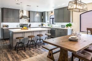 a kitchen with gray cabinets and a wooden table at Historic Oldtown Plaza 201 in Scottsdale
