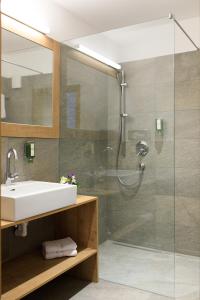 a bathroom with a sink and a shower at Laura´s Smart Apartment in Innsbruck