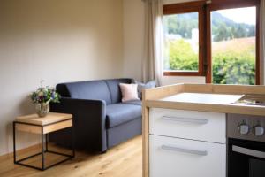 a living room with a couch and a table at Laura´s Smart Apartment in Innsbruck