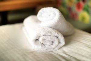 a stack of towels sitting on top of a bed at Laura´s Smart Apartment in Innsbruck