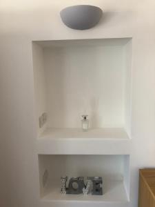 a room with white walls and a white shelf at Bournemouth Hot Tub & Sauna Holiday Let in Bournemouth