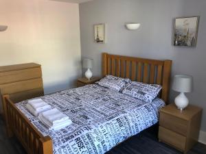 a bedroom with a bed with towels on it at Bournemouth Hot Tub & Sauna Holiday Let in Bournemouth