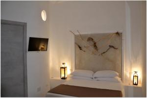 Кровать или кровати в номере Quintessenza - Charme Rooms
