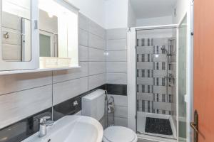 a bathroom with a toilet and a sink and a mirror at Apartmenst Saban 1709 in Murine +37 photos