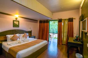 Katil atau katil-katil dalam bilik di Upavan Resort