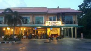 a hotel with two motorcycles parked in front of it at Phangan Guest House in Thong Sala