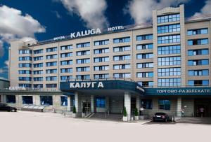 a large hotel with a sign on the front of it at Historical Hotel Kaluga in Kaluga