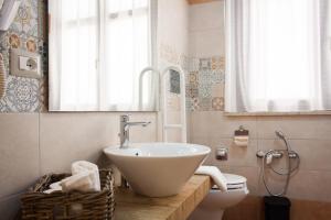a bathroom with a sink and a toilet at Case Vacanze Al Duomo in Licata +113 photos