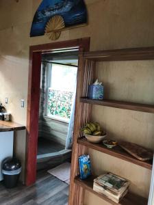 a kitchen with a window and a bowl of bananas at Volcano Eco Cabin & Eco Lodge in Volcano