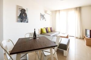 a dining room with a wooden table and chairs at Seaside Apartment NLV in Sunny Beach
