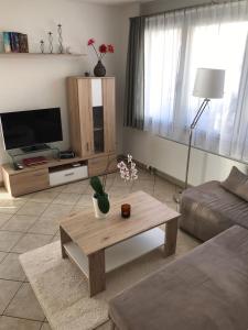 a living room with a couch and a coffee table at Chasa Furtüna in Ftan