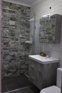 a bathroom with a sink and a glass shower at Blue4Aqua Apartments in Kavála