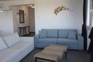 a living room with a couch and a table at Blue4Aqua Apartments in Kavála