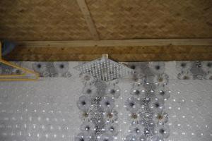 a chandelier hanging from the ceiling of a room at Vamoose Orchid Villa Homestay in Rinchingpong