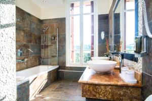 a bathroom with two sinks and a tub and a sink at Villa Morelia in Jausiers +43 photos