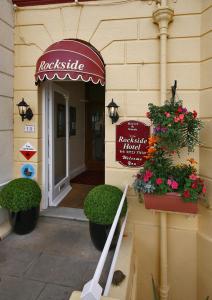 an entrance to a restaurant with flowers in pots at The Rockside in Scarborough