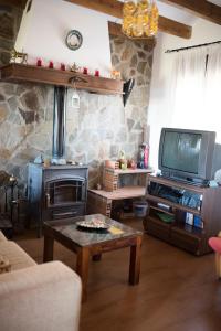 a living room with a wood stove and a tv at Mi Casita in Ronda