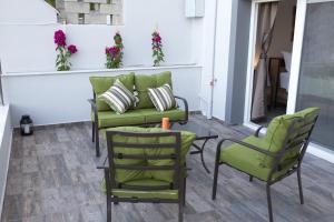 a patio with two chairs and a couch and a table at Blue4Aqua Apartments in Kavála