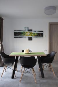 a dining room with a wooden table and chairs at Blue4Aqua Apartments in Kavála