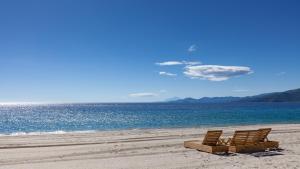 two beach chairs sitting on the sand on the beach at Αvra Strymonikou in Stavros +30 photos