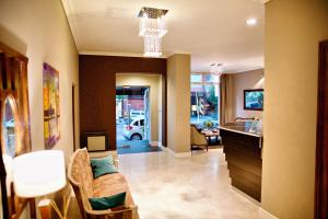 a living room with a couch and a table at Galeon Mar del Plata Hotel in Mar del Plata