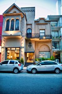 
cars parked in front of a building at Galeon Mar del Plata Hotel in Mar del Plata
