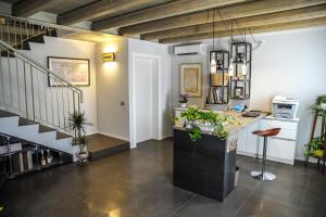 an office with a staircase and a counter with plants at Corte Grisela Wine&Relax in Monteforte dʼAlpone