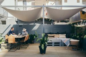 two people sitting at a table on a patio at Hotel Brummell in Barcelona