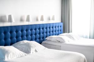 Voodi või voodid majutusasutuse Hotel Flora toas