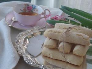 a plate of cookies and a cup of tea at Casa Vacanze "Un sogno nel Blu'" in Baunei +13 photos