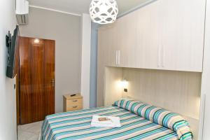 
a bedroom with a bed and a dresser at Bluemarine Apartment in Gallipoli

