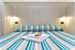 a bed with a plate of food on top of it at Bluemarine Apartment in Gallipoli