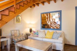 a living room with a couch and a table at Hotel Cortijo del Arte - Caminito del Rey in Pizarra