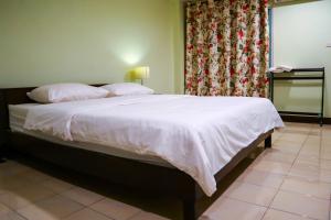 een slaapkamer met een groot bed met witte lakens en kussens bij Udoncabana in Udon Thani
