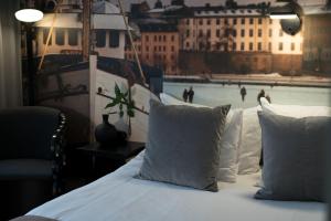 a bed with white pillows with a view of the water at Hotel C Stockholm in Stockholm +48 photos