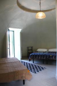 a bedroom with two beds and a chandelier at Astrocamp in Verghereto