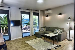 a living room with a couch and a table at Cos Seafront Apartments in Gerakini