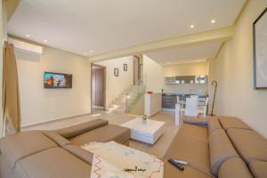 a living room with a couch and a table at Mnar Park aqua park in Tangier